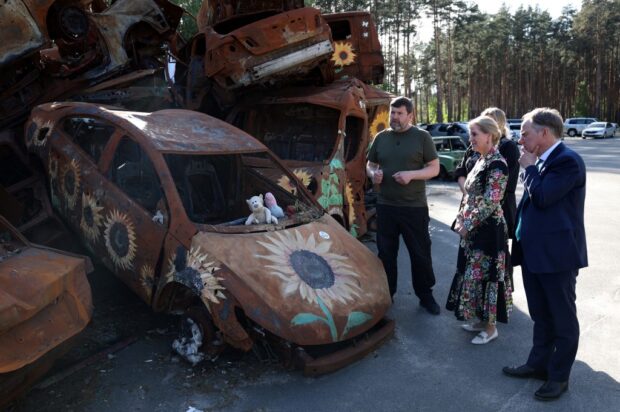 Britain's Sophie, Duchess of Edinburgh, and the Ambassador of the United Kingdom to Ukraine Martin Harris (R) visit the Car Cemetery