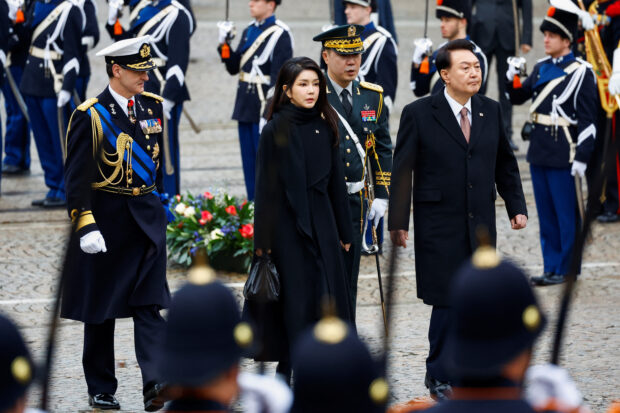 South Korea's President Yoon Suk Yeol and his wife Kim Keon Hee walk during a ceremony in Amsterdam, Netherlands 