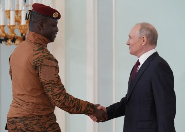 This pool image distributed by Sputnik agency shows Russian President Vladimir Putin meeting with Burkina Faso's junta leader Captain Ibrahim Traore in Strel'na outside Saint Petersburg on July 29, 2023. (Photo by Alexey DANICHEV / POOL / AFP)