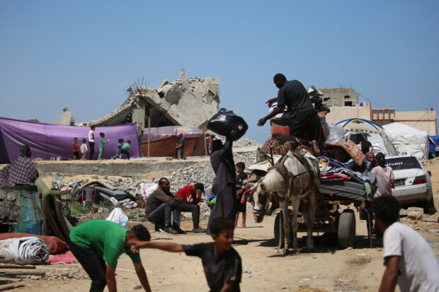 Displaced Palestinians load their belongings on the back of a horse-pulled cart as they flee al-Mawasi to a safer area in Rafah in the southern Gaza Strip on May 9, 2024, amid the ongoing conflict between Israel and militants from the Hamas movement. The United Nations agency supporting Palestinian refugees said on May 9 