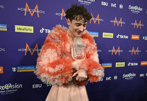 This year's winner Nemo, representing Switzerland, holds their trophy after the final of the 68th edition of the Eurovision Song Contest (ESC) at Malmö Arena, in Malmö, Sweden, May 12, 2024. Switzerland's Nemo won the Eurovision Song Contest Saturday, the first artist identifying as non-binary to do so, in a contest marked by controversy over Israel's participation during the war in Gaza. (Photo by Jessica Gow/TT / TT NEWS AGENCY / AFP) / Sweden OUT