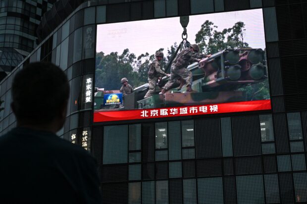 An outdoor screen shows a news coverage of China’s military drills around Taiwan, in Beijing on May 23, 2024. China launched on May 23 what it called "Joint Sword-2024A" exercises, surrounding Taiwan with warplanes and navy ships and vowing "stern punishment" of separatist forces on the island.
