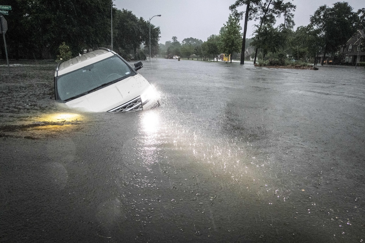 PHOTO: An SUV is stranded in a ditch in Texas during flooding STORY: Heavy rains in Texas close schools, flood roadways