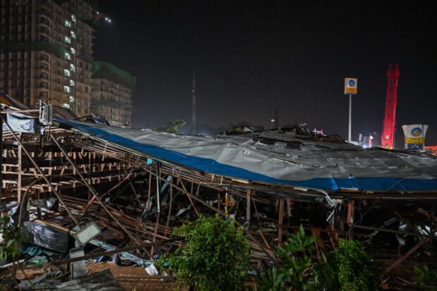 This photograph shows the site where an advertisement billboard collapsed at a petrol station following a dust storm in Mumbai on May 13, 2024. 