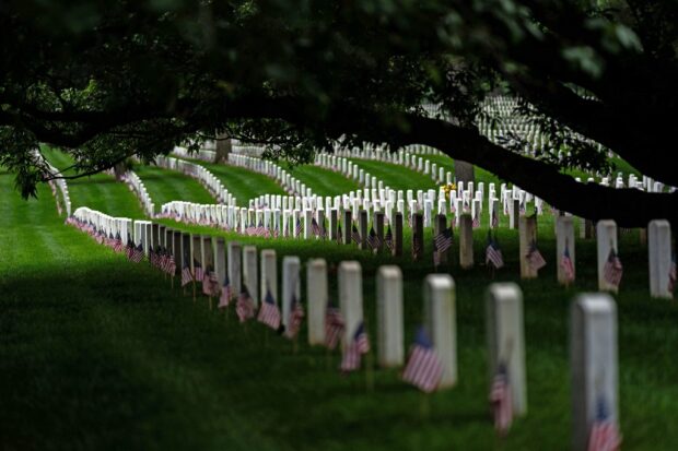 ARLINGTON, VIRGINIA - MAY 27: The rolling hills of headstones mark the final resting place of service men and women at Arlington National Cemetery on May 27, 2024 in Arlington, Virginia. 