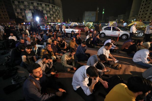 Iranians pray for President Ebrahim Raisi and Foreign Minister Hossein Amir-Abdollahian in Valiasr Square in central Tehran on May 19, 2024. 