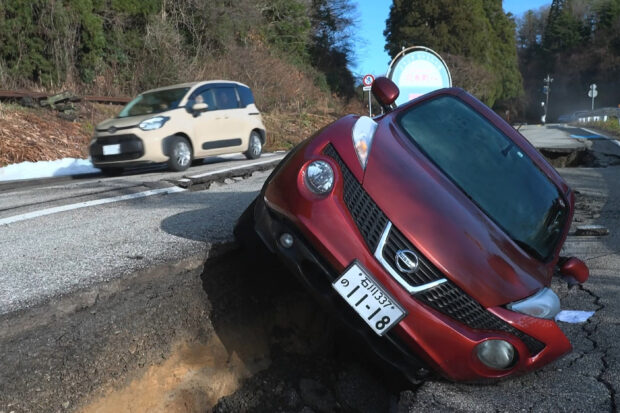 This screen grab from AFPTV video footage taken on January 2, 2024 shows a damaged car left on the side of the road in Wajima, Ishikawa prefecture, a day after a major 7.5 magnitude earthquake struck the Noto region in Ishikawa prefecture. Japanese rescuers battled against the clock and powerful aftershocks on January 2 to find survivors of a major earthquake that struck on New Year's Day, killing at least six people and leaving a trail of de