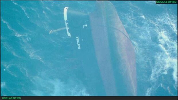 A handout picture released by the US Central Command (CENTCOM) on March 2, 2024 shows the capsized Belize-flagged UK-owned bulk carrier Rubymar in the Red Sea, after taking damage due to a February 18 missile strike claimed by Yemen's Huthi group. The sinking of a Belize-flagged bulker off Yemen after a Huthi missile attack poses grave environmental risks, with fuel leaks and fertilizer cargo pouring into the Red Sea, according to officials and experts. (Photo by AFP) / RESTRICTED TO EDITORIAL USE - MANDATORY CREDIT "AFP PHOTO /US CENTCOM" - NO MARKETING NO ADVERTISING CAMPAIGNS - DISTRIBUTED AS A SERVICE TO CLIENTS