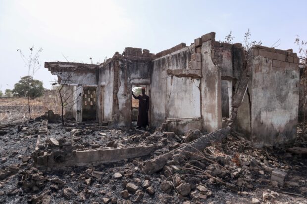 This photograph taken on March 31, 2024 shows Vice Principal Bature Sule surveying the wreckage of a dormitory destroyed by Boko Haram fighters at the Chibok Government Girls Secondary School in 2014. A decade since Nigeria's most infamous mass abduction, almost 100 of the 276 girls seized from their school in Chibok by Boko Haram fighters are still thought to be in captivity.The anniversary of the April 14, 2014 attack comes during a resurgence of large-scale kidnappings, with no end in sight to the war that has killed more than 40,000 people in northeast Nigeria. Laurie Churchman / AFP 