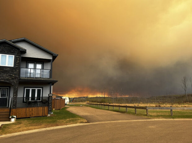 This handout image courtesy of Kosar shows smoke and flames from the fire in Fort McMurray, ALberta, Canada on May 14, 2024 as residents from the area of Abasand Heights evacuate the area. Four neighborhoods of Fort McMurray, a city in Canada's major oil-producing region, were ordered evacuated May 14 as an out of control wildfire drew near and the skies filled with smoke.Shifting winds gusting to 40 kilometers per hour (25 miles per hour) fanned the flames, scorching 9,600 hectares of surrounding forests as it advanced to within 13 kilometers (eight miles) of the city that had previously been gutted by wildfires in 2016 -- one of the biggest disasters in the nation's history.
Thousands of residents in the neighborhoods of Prairie Creek, Abasand, Grayling Terrace and Beacon Hill were ordered out by 4 pm local time. By mid-afternoon, a highway south was jammed with cars and trucks. 