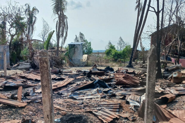 This photo taken on May 21, 2024 shows a destroyed house and burned trees following fighting between Myanmar's military and the Arakan Army (AA) ethnic minority armed group in a village in Minbya Township in western Rakhine State. Fighting has rocked Myanmar's western Rakhine state since the Arakan Army (AA) attacked the junta there in November last year, and according to the UN more than 100,000 people have been displaced by conflict in the state since then.