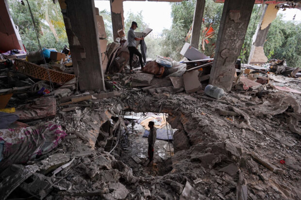 Palestinians inspect the damage to a house after it was hit in an Israeli strike in al-Bureij camp in the central Gaza Strip on June 3, 2024, amid the ongoing conflict between Israel and the Palestinian Hamas militant group.