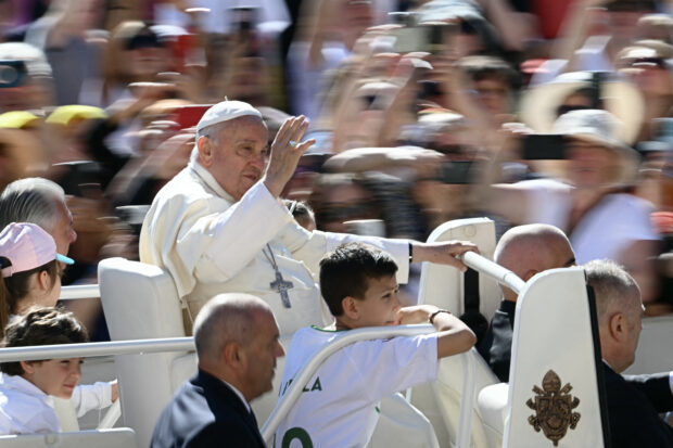 Pope Francis waves from the popemobile as he arrives for the weekly general audience on June 5, 2024 at St Peter's square in The Vatican. 