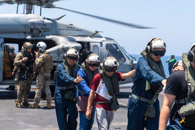 This handout picture courtesy of the US Naval Forces Central Command released on June 15, 2024 shows sailors from the Dwight D. Eisenhower Carrier Strike Group rendering assistance to distressed mariners at sea in the Red Sea, on June 15, 2024. The crew of a ship that was holed in an attack by Yemen's Huthi rebels has been evacuated and the vessel is drifting in the Red Sea, a security agency said on on June 15. The Huthis, who control much of Yemen, seized Sanaa in 2014, prompting a Saudi-led military intervention in support of the government the following year. They say their scores of Red Sea attacks since November are in support of Palestinians in Gaza