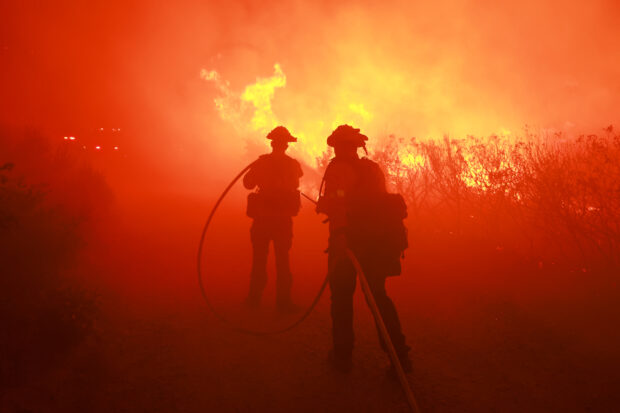 Firefighters from the Los Angeles Fire Department (LAFD) and other firemen respond to the Post Fire as it burns through the Hungry Valley State Vehicular Recreation Area in Lebec, California, on June 16, 2024. The fire has grown to 4,400 acres, with evacuation orders in place for Gorman, Pyramid Lake and Hungry Valley State Vehicular Recreation Area, according to the US Department of Agriculture Forest Service at Los Padres National Forest. 