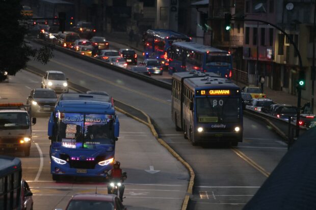Two buses travel on a main road during a blackout in Quito June 19, 2024. Ecuador blacked out on June 19, due to failures in the supply network, according to Deputy Energy Minister Roberto Luque, affecting strategic services such as telecommunications and the Quito metro
