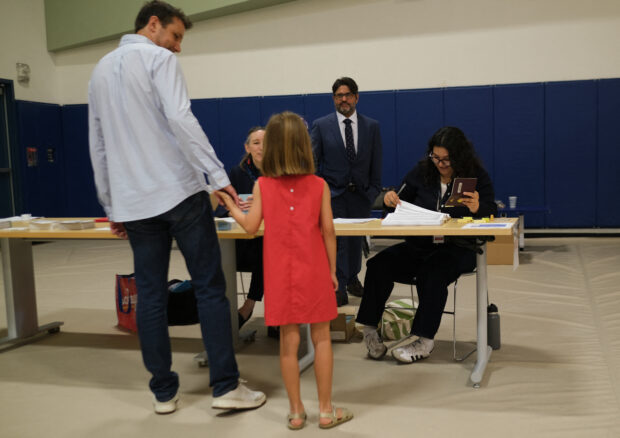 French nationals vote at the Lycée Français de Los Angeles during the first round of French legislative elections, in Los Angeles, on June 29, 2024. A divided France braced June 29, 2024 for high-stakes parliamentary elections that could see the anti-immigrant and eurosceptic party of Marine Le Pen sweep to power in a historic first.