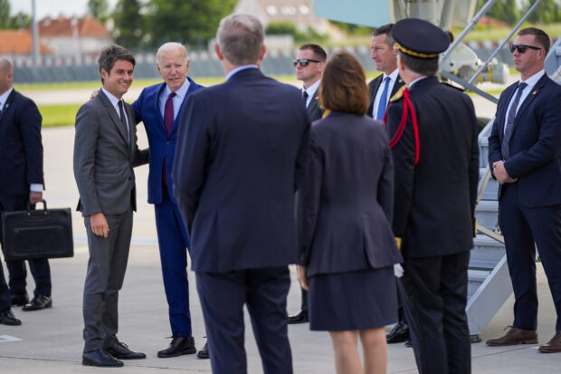 President Joe Biden is welcomed by France's Prime Minister Gabriel Attal, left, 