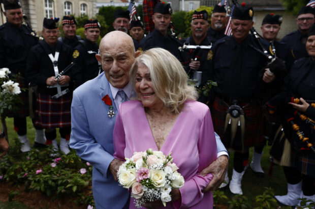 US WWII veteran Harold Terens, 100, left, and Jeanne Swerlin, 96, arrive to celebrate their wedding at the town hall of Carentan-les-Marais, in Normandy, northwestern France, on Saturday, June 8, 2024.
