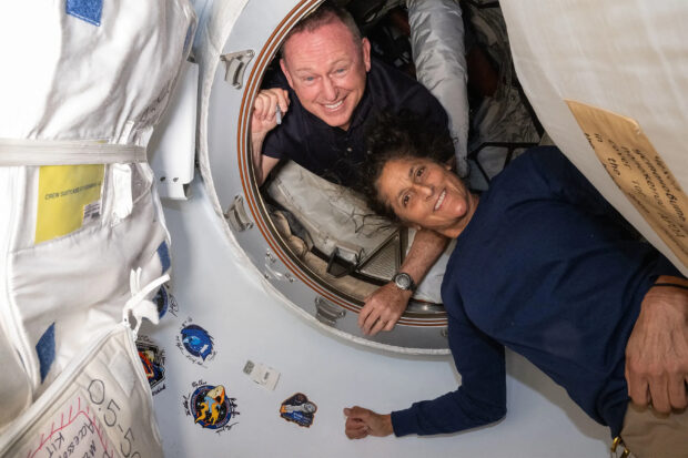 This undated handout picture from Nasa released on July2, 2024 shows NASA’s Boeing Crew Flight Test astronauts (from top) Butch Wilmore and Suni Williams inside the vestibule between the forward port on the International Space Station’s Harmony module and Boeing's Starliner spacecraft. The first astronauts to fly Boeing's troubled Starliner are definitely not "stranded" at the International Space Station, NASA insisted on June 28, 2024 despite having no clear timeframe for bringing them home. In an unusually defensive press call, officials attempted to put a positive spin on where things currently stood after weeks of negative headlines due to the spaceship's delayed return. 