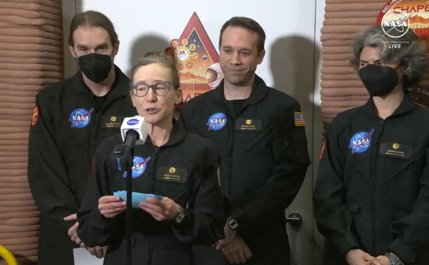 In this still image taken from a July 6, 2024, NASA TV broadcast, volunteer crew commander Kelly Haston speaks alongside crewmates (L-R) Ross Brockwell, Nathan Jones and Anca Selariu, as they exit the first simulated yearlong Mars habitat mission at Johnson Space Center in Houston, Texas. The crew's mission began in the 3D printed Mars habitat on June 25, 2023. (Photo by Jose ROMERO / NASA TV / AFP)