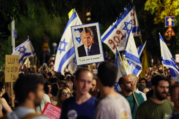 Protesters lift flags and placards as they march to call for the release of Israelis held hostage by Palestinian militants in Gaza since the October attacks, in Jerusalem on July 7, 2024, amid the ongoing conflict in the Gaza Strip between Israel and the Palestinian militant Hamas group. Israel launched deadly strikes on July 7, on the Gaza Strip as its war against Hamas entered its 10th month, with diplomatic efforts underway to secure a ceasefire and hostage release deal. 