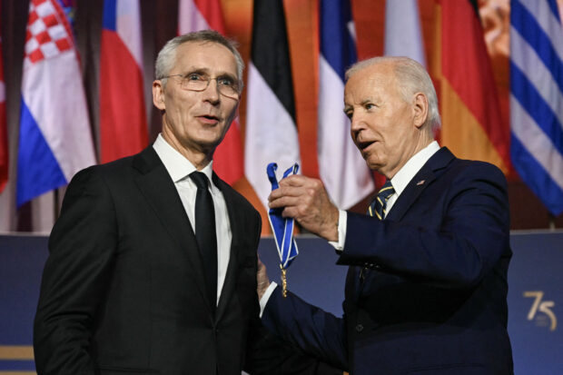 US President Joe Biden (R) awards the Presidential Medal of Freedom to NATO Secretary General Jens Stoltenberg (L) during the NATO 75th Anniversary Celebratory Event at the Mellon Auditorium in Washington, DC, on July 9, 2024. 