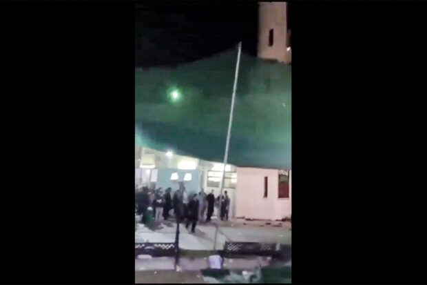 This image grab from a UGC video taken on July 16, 2024 shows shows people fleeing the scene of a shooting at the Imam Ali Mosque in the Al-Wadi Al-Kabir area in the east of Oman's capital Muscat. Four people were killed and multiple others wounded in the incident, police said on July 16. Such an attack is rare in the Sultanate, which has regularly played the role of mediator in regional conflicts. Shiites this week mark Ashura, an annual day of mourning that commemorates the 7th-century battlefield martyrdom of Hussein. 