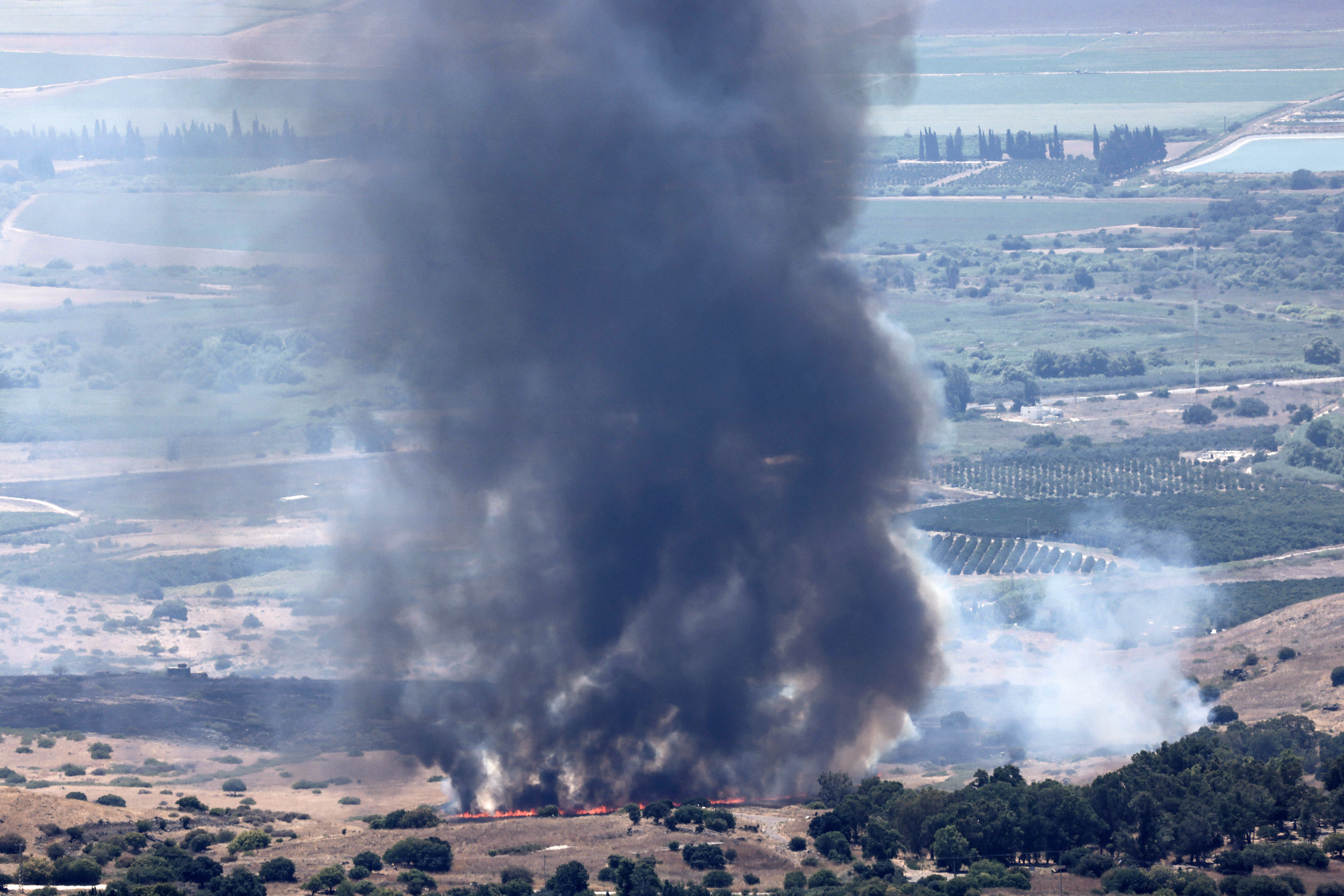 Smoke billows after a hit from a rocket fired from southern Lebanon over the Upper Galilee region in northern Israel on July 21, 2024.