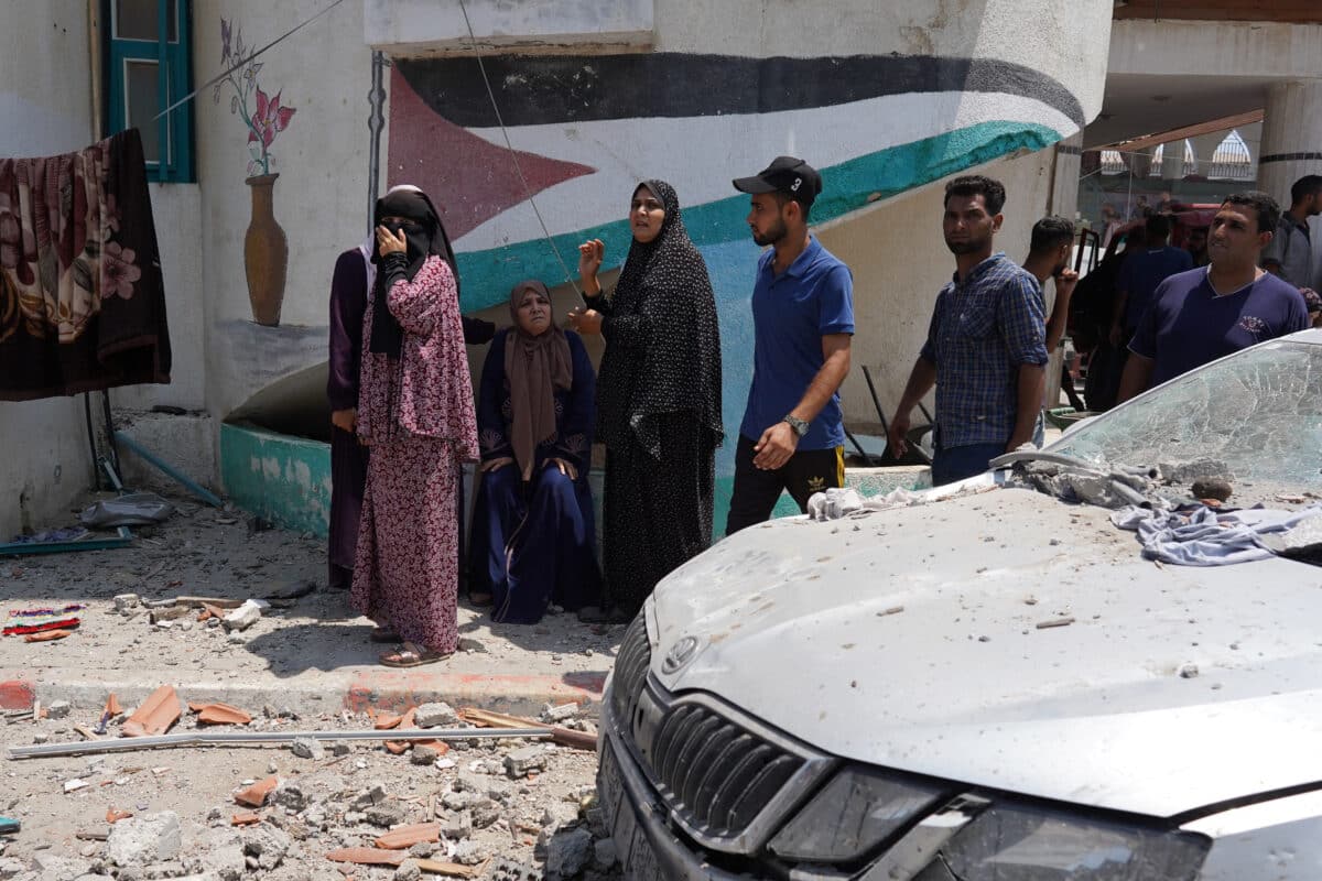 Palestinians flee from a school where they had taken refuge, after it was hit by an Israeli strike, in Deir el-Balah in the central Gaza Strip on July 27, 2024, amid the ongoing conflict between Israel and the Palestinian militant group Hamas.