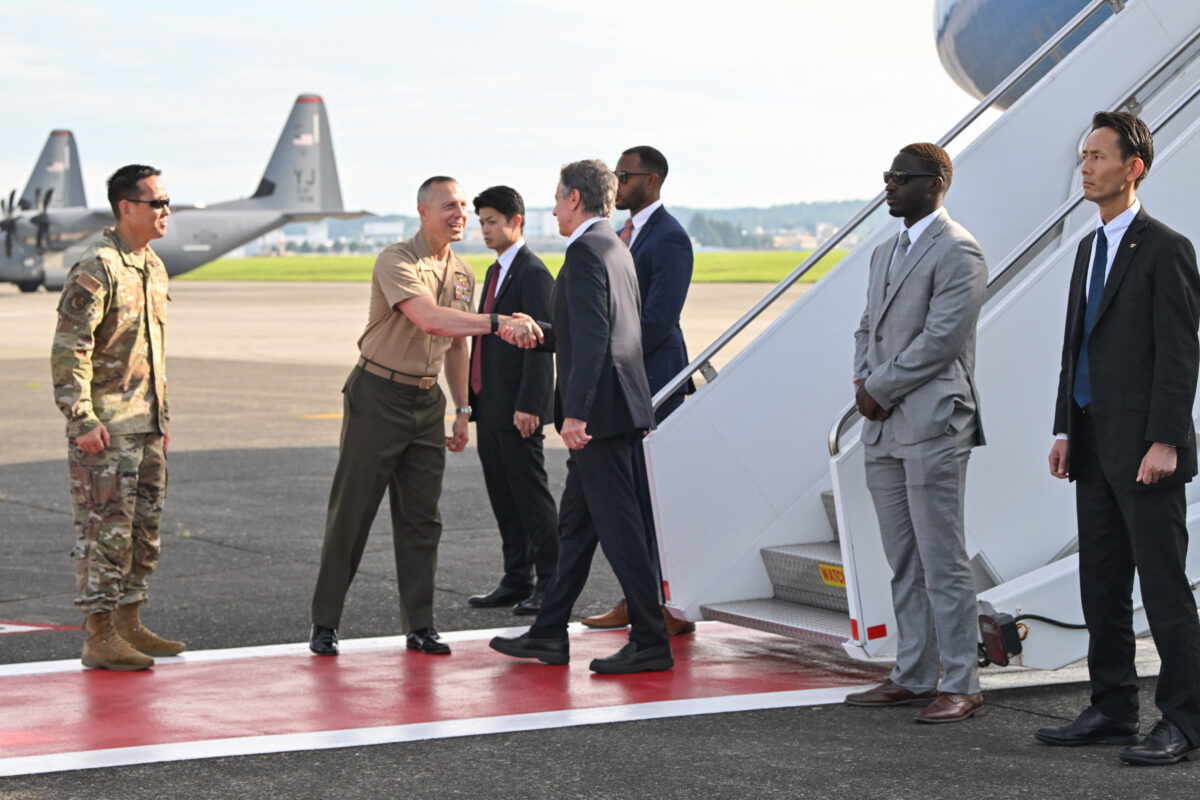 US Secretary of State Antony Blinken (C) is welcomed upon arrival for the start of his two-day visit, at Yokota Air Base in Fussa, western Tokyo, on July 28, 2024. (Photo by Kazuhiro NOGI / POOL / AFP)