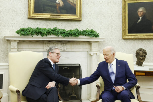 U.S. President Joe Biden (R) and British Prime Minister Keir Starmer (L) shake hands while speaking to reporters before a bilateral meeting in the Oval Office of the White House on July 10, 2024 in Washington, DC. Starmer is visiting the United States to participate in the 2024 NATO summit. 