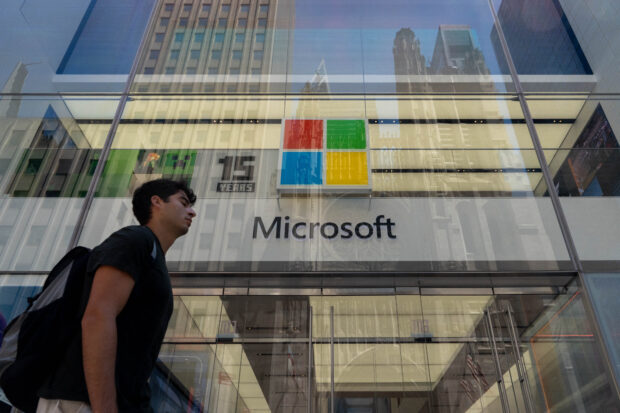 People walk past the Microsoft store on Fifth Avenue on July 19, 2024 in New York City. Businesses and transport worldwide were affected by a global technology outage that was attributed to a software update issued by CrowdStrike