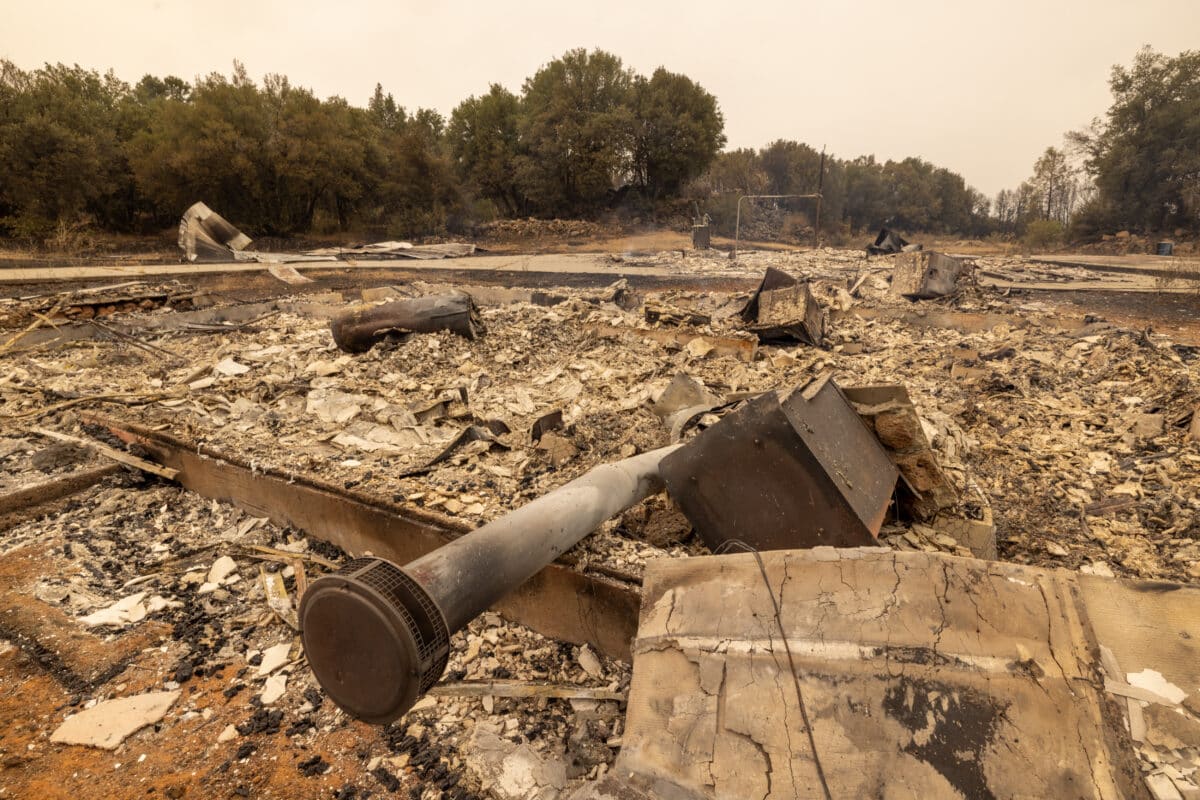 CHICO, CALIFORNIA - JULY 27: An old ranch house is reduced to ash near the small community of Payne Creek as the Park Fire continues to expand on July 27, 2024 near Chico, California. The Park Fire has grown to 348,370 acres and is still 0 percent contained. Strong winds and dried vegetation fueled the fire that exploded 70,000 acres in the first 24 hours after a man allegedly pushed a burning car into a ravine to intentionally set the blaze. In 2018, more than 18,000 structures were destroyed and 85 people killed in the nearby town of Paradise when the Camp Fire entrapped thousand of people and became the deadliest and most destructive fire in California history. David McNew/Getty Images/AFP (Photo by DAVID MCNEW / GETTY IMAGES NORTH AMERICA / Getty Images via AFP)