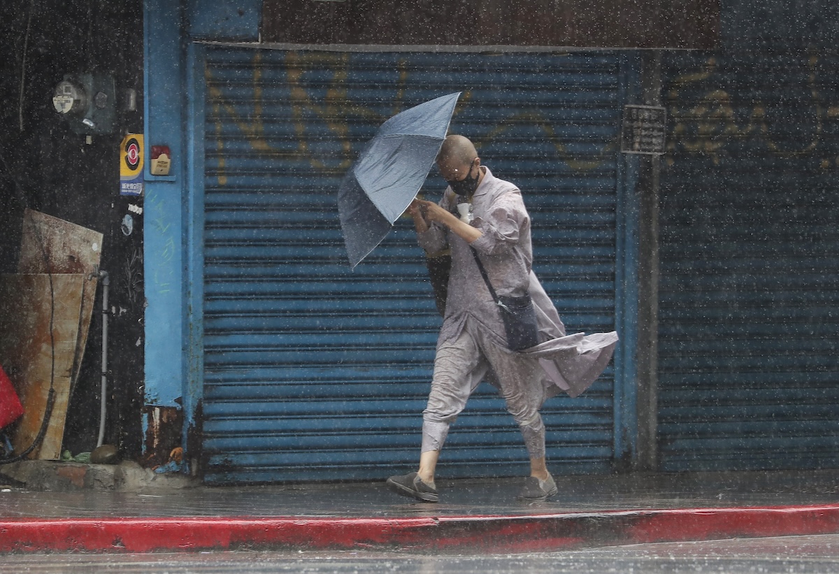 PHOTO: A Buddhist nun struggles with her umbrella against gusts of wind generated by Typhoon Gaemi in Taipei, Taiwan, Wednesday, July 24, 2024. STORY: Taiwan prepares for a strong Typhoon Gaemi that killed 13 in PH