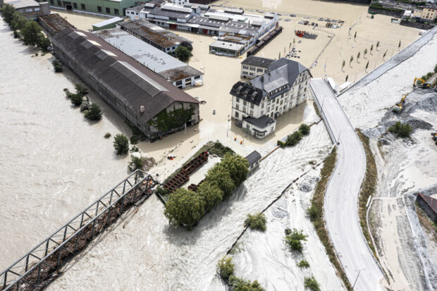 A view of the Rhone river, at left, and the Navizence river overflowing in the industrial zone that produces aluminium "Constellium," following the storms that caused major flooding, in Chippis, Switzerland, Sunday, June 30, 2024. The Rhone river burst its banks in several areas of Valais canton, flooding a highway and a railway line.