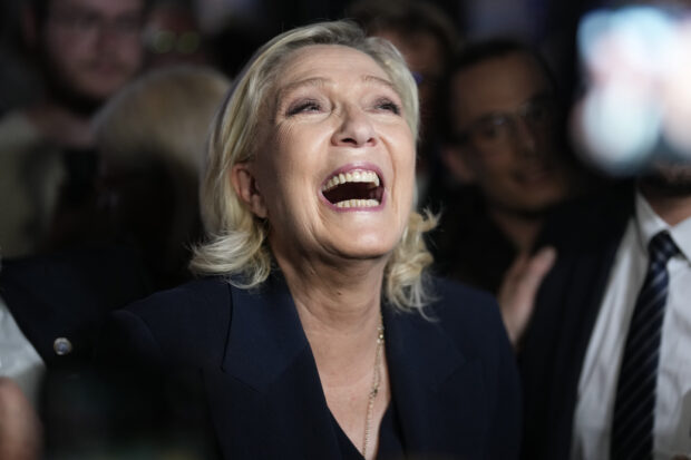 French far right leader Marine Le Pen reacts as she meets supporters and journalists after the release of projections based on the actual vote count in select constituencies , Sunday, June 30, 2024 in Henin-Beaumont, northern France. French voters propelled the far-right National Rally to a strong lead in first-round legislative elections Sunday and plunged the country into political uncertainty, according to polling projections.