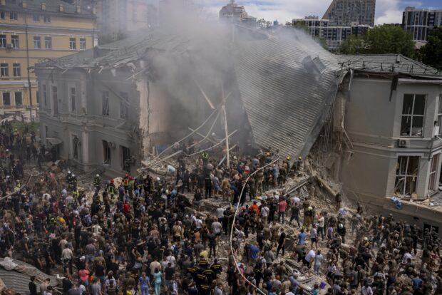 Emergency workers respond at the Okhmatdyt children's hospital hit by Russian missiles, in Kyiv, Ukraine, Monday, July 8, 2024. A major Russian missile attack across Ukraine on Monday killed at least 31 people and injured 154, officials said, with one striking a large children’s hospital in the capital of Kyiv, where emergency crews searched the rubble for victims.