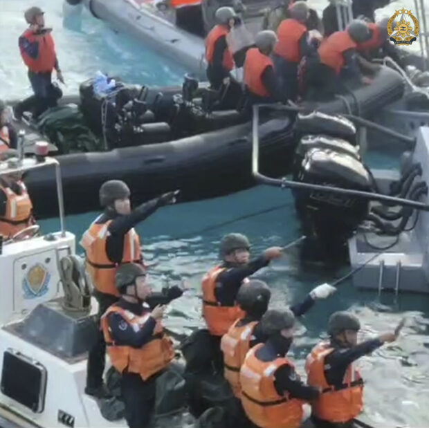  In this handout image provided by Armed Forces of the Philippines, Chinese Coast Guard hold knives and machetes as they approach Philippine troops on a resupply mission in the Second Thomas Shoal at the disputed South China Sea on June 17, 2024. A recently signed agreement will allow representatives of Chinese President Xi Jinping and his Philippine counterpart and their top diplomats to call each other to try to prevent any new confrontation from spiraling out of control in the disputed South Chin