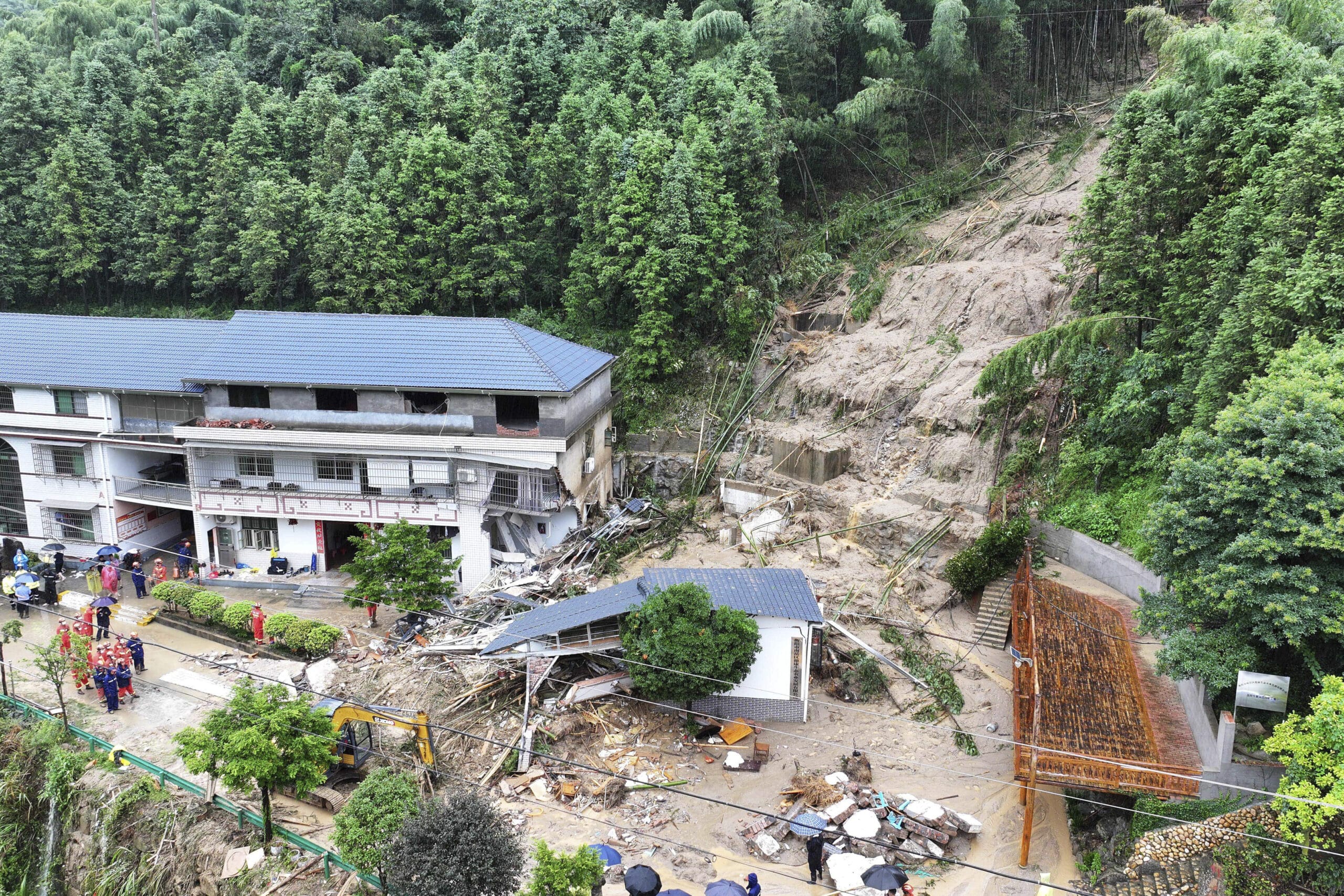 In this drone photo released by Xinhua News Agency, a landslide destroys a house in Yuelin village of Shouyue town of Hengyang city, central China's Hunan Province on Sunday, July 28, 2024.