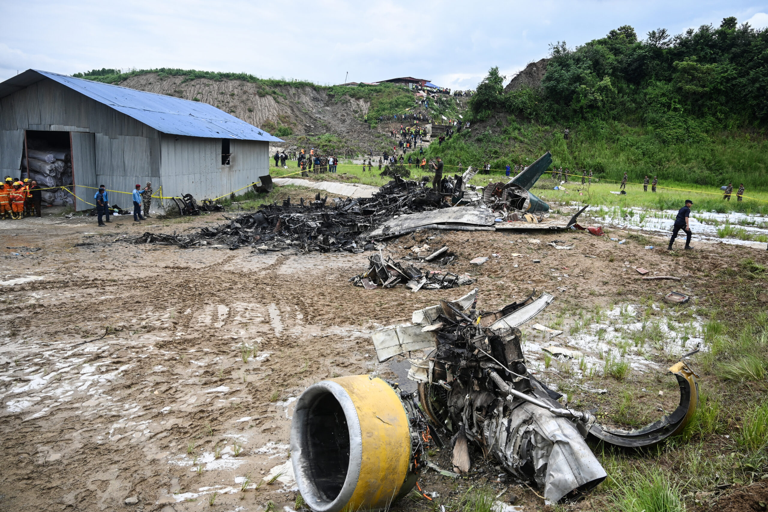 Rescuers work at the site after a Saurya Airlines' plane crashed during takeoff at Tribhuvan International Airport in Kathmandu on July 24, 2024. 