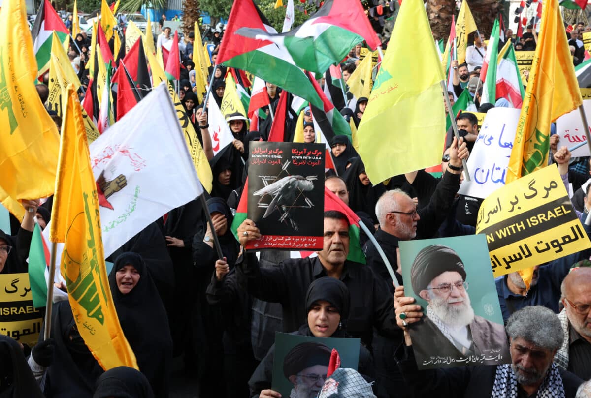 Iranians wave Palestinian flags and hold placards during a protest denouncing the killing of the leader of the militant group Hamas, at Palestine square in the Iranian capital Tehran on July 31 2024. The Palestinian militant group Hamas said on July 31, its political leader Ismail Haniyeh was killed in an Israeli strike in Iran, where he was attending the swearing-in of the new president, and vowed the act "will not go unanswered". 