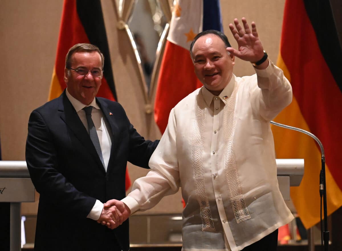 Philippine Defense Secretary Gilberto Teodoro (R) shakes hands with German Defense Minister Boris Pistorius