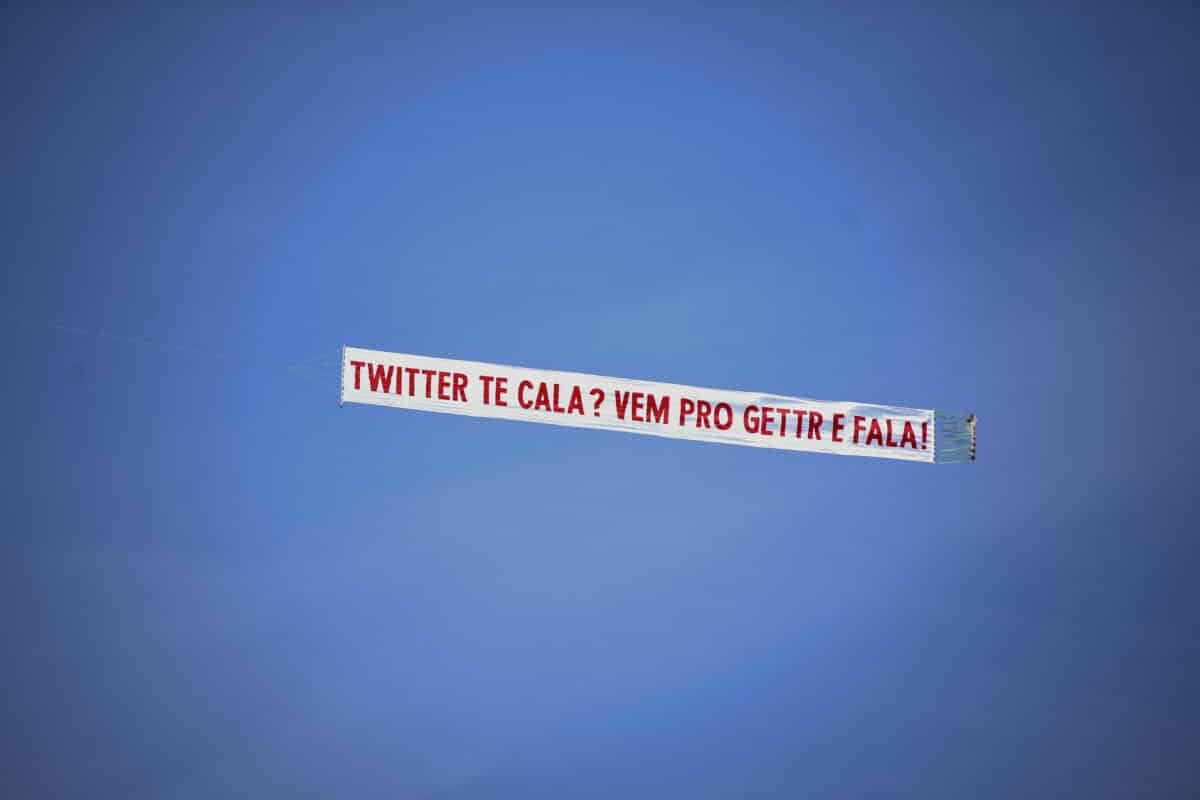 A small plane carries a banner that reads "Twitter shuts you up? Come to GETTR and talk", in promotion of the US social media company targeted to conservative voters founded by Jason Miller, a former Donal Trump aide and spokesman, during a demonstration in support of Brazilian President Jair Bolsonaro at Copacabana beach in Rio de Janeiro, Brazil, on September 7, 2021, amidst Brazil's Independence Day. Fighting record-low poll numbers, a weakening economy and a judiciary he says is stacked against him, President Jair Bolsonaro has called huge rallies for Brazilian independence day Tuesday, seeking to fire up his far-right base. (Photo by MAURO PIMENTEL / AFP)