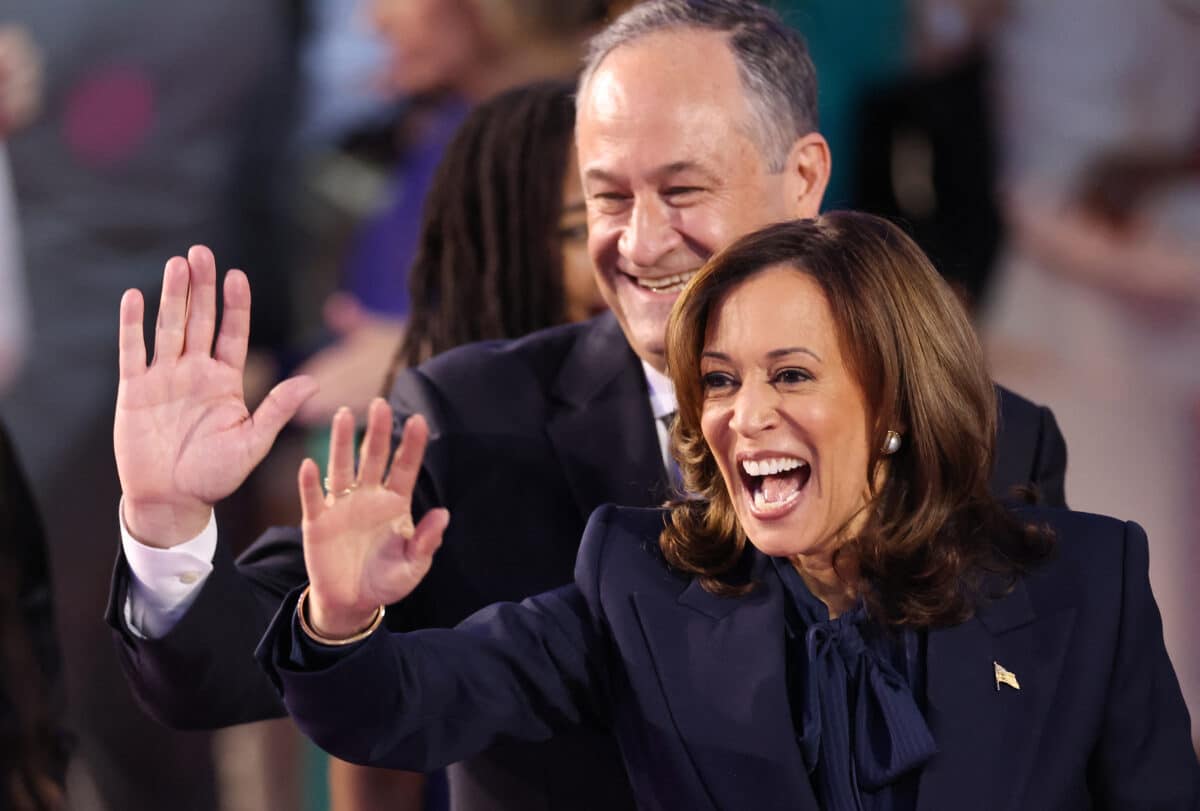 US Vice President and 2024 Democratic presidential candidate Kamala Harris and her husband US Second Gentleman Douglas Emhoff wave from the stage on the fourth and last day of the Democratic National Convention (DNC) at the United Center in Chicago, Illinois, on August 22, 2024. - Vice President Kamala Harris formally accepted the partys nomination for president today at the DNC which ran from August 19-22 in Chicago. 