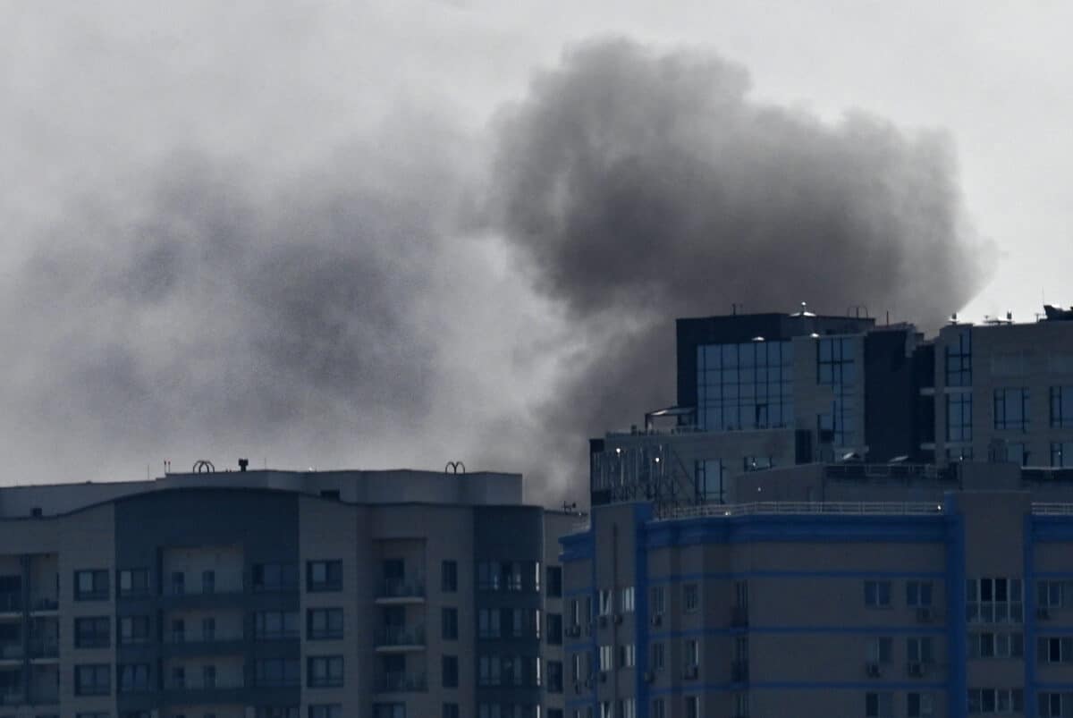 This photograph shows smoke rises over buildings, following a Russian drones attack in Kyiv, on August 26, 2024, amid the Russian invasion of Ukraine. - Russian drones and missiles on August 26, 2024, targeted 15 regions across Ukraine in an overnight barrage aimed mainly at energy infrastructure, Ukrainian Prime Minister Denys Shmygal said.  