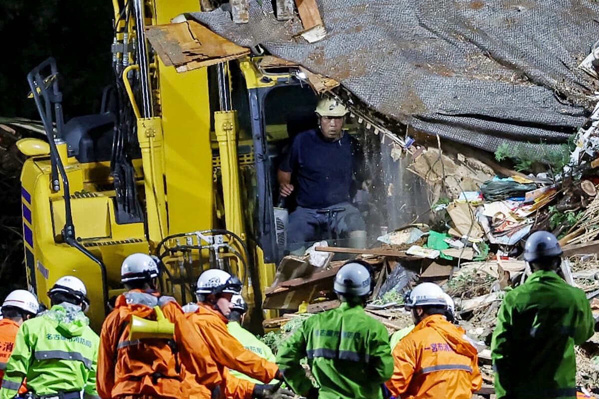 Rescue personnel conduct a search operation after landslide in Gamagori, Aichi prefecture on August 28, 2024. - Japan braced on August 28, for its strongest typhoon of the year, with authorities advising tens of thousands of people to evacuate and issuing the highest warning level for wind and storm surges on the main southern island of Kyushu.