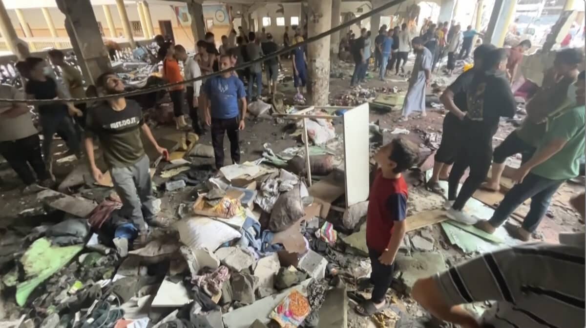 In this image made from a video, people inspect the dome at a school after being hit by an Israeli airstrike in Gaza City Saturday, Aug. 10, 2024. 