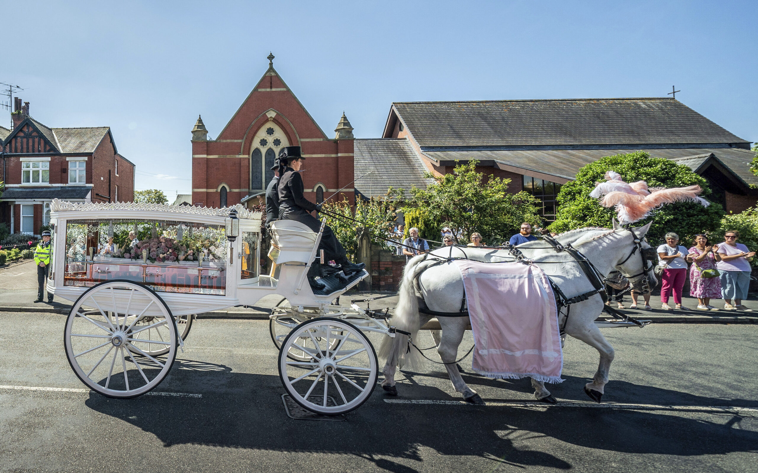 English town mourns 9-year-old stabbing victim, calls for end to unrest