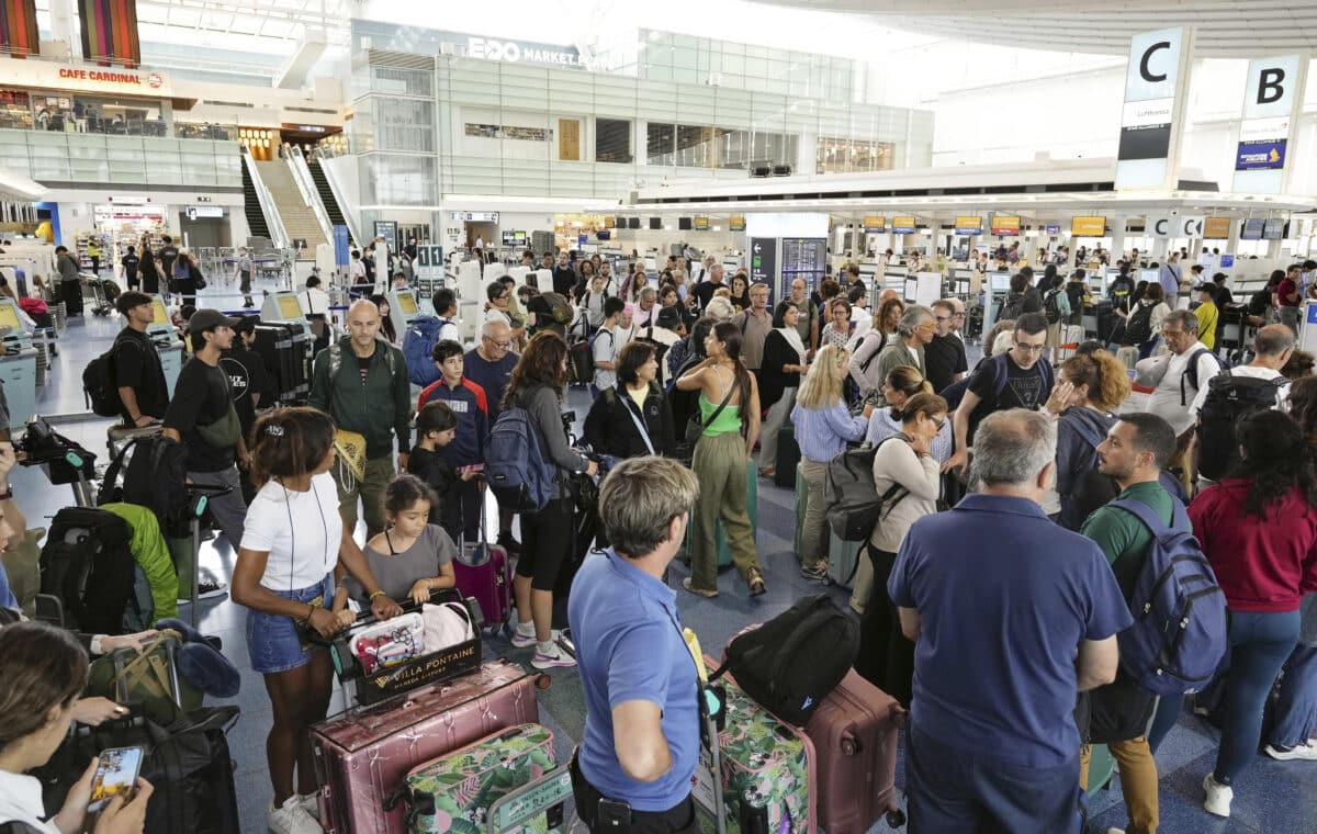 Passengers are seen at the international flight terminal at the Haneda airport, in Tokyo, Japan, as a strong typhoon approaches Tokyo area, Friday, Aug. 16, 2024. (Kyodo News via AP)